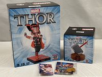 Two sealed Thor boxes, Stan Lee pin package, Groot charms