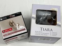 Delta Lyndall hook box beside Tiara robe hook box