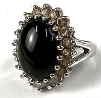 Front view showing black cabochon and clear stone halo