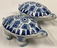 Two blue and white porcelain turtle figurines side by side