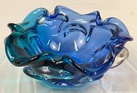 Angled view showing ruffled rim and blue-teal color gradient