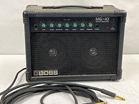 Front view of Boss MG-10 amplifier with Rapco cable