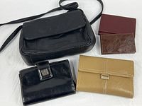 Group shot of purse, three wallets, business card case