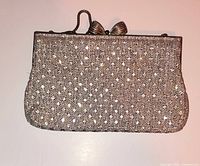 Front view of silver rhinestone mesh evening bag showing frame, clasp and handle
