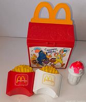 Front view of whole set closed Happy Meal box, fries, shake