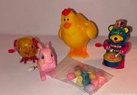 All four wind-up toys and bag of eggs group view