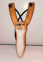 Front view showing carved feline face and overall shape