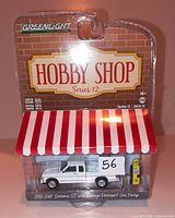 Front view of sealed GreenLight Hobby Shop Series 12 package containing 1991 GMC Sonoma ST diecast and gas pump
