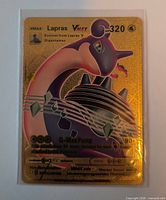 Front view of Lapras VMAX gold foil card in protective sleeve