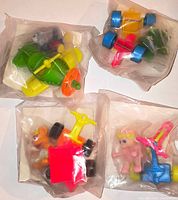 Four sealed polybag Muppet Babies pull-back vehicle toys