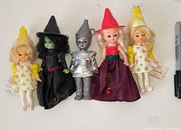 Front view of all five Wizard of Oz dolls standing side by side showing costumes and size
