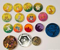 All 16 Pokémon pogs and slammers laid out face up