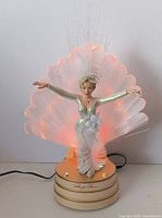 Front view of illuminated Marilyn Monroe fiber-optic figurine showing fan and base