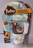 Front of sealed Poopeez Toilet Launcher Playset showing toilet launcher and characters