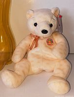 Full view of Ty Beanie Baby Popcorn bear seated upright showing ribbon, badge and swing tag