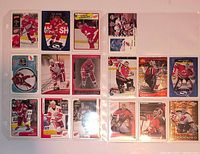 Fronts of two 9-pocket pages showing 18 cards (Yzerman left page, Brodeur right page)