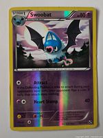 Front view of Swoobat holographic Pokémon card showing card details and condition