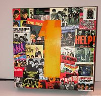 Front of sealed Beatles album covers puzzle box showing collage artwork and shrink wrap