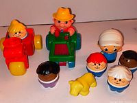 Overview of five Little People figures, two vehicles, yellow dog