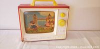 Front view showing Fisher-Price Two Tune TV, screen illustration, knobs and handle