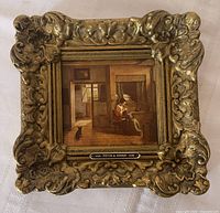 front view showing entire ornate gilt frame and print