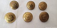 Six brass Penitentiaries Canada uniform buttons showing crown emblem