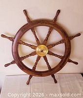 Full view of 8-spoke wooden ship wheel with brass hub