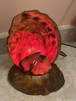 Lamp illuminated showing red glow inside abalone shell