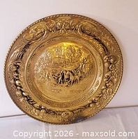 Front view showing full embossed brass plate with pastoral carriage scene and ornate border