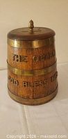 Front view of oak rum tub showing brass bands and lettering