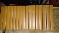 Sixteen brown hardcover Awake! annual volumes lined up spine-out