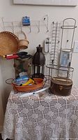 Full lot showing lantern, baskets, garden tools, towel grips, planter, cosmetic case, wire racks