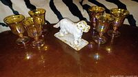 Full lot showing six goblets and cast-iron dog figurine