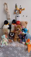 Group shot of all plush items on lace-covered table