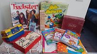 Group shot showing Twister, Mr. Mouth, Disney Trivia, dominoes, stacking tower, puzzle books, cat card deck