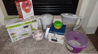 Group shot showing all boxed items, pitchers, storage bowl, silicone cups, scale