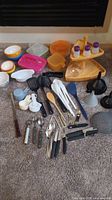 Entire lot laid out on carpet showing containers, utensils, tiered tray and funnels