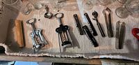 Tray showing two wing corkscrews, waiter corkscrews, tongs, bar spoon, muddler