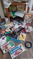 Overview of entire lot showing looms, craft kits, plastic canvas sheets