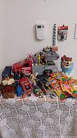Group shot of toys including Tonka truck, missile truck, Taz mug, sealed foil packs