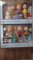Two boxed Peanuts A Charlie Brown Christmas figure sets stacked