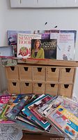 Organizer, books on top, decorative box, stack of pattern booklets in front