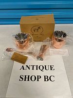 Full set showing two mugs, jigger, spoon, box, paperwork