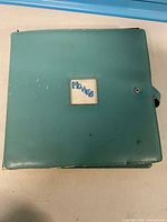 Closed teal binder labeled Movies