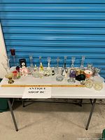 Full table view showing entire lot of glass and porcelain items