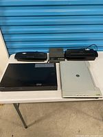 Group shot of Blu-ray player, scanner, answering machine and two shredders on table