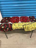 Finished floral needlepoint placemats/covers displayed on table