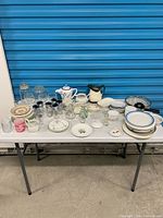 Full table view showing all china, glassware, pitchers, plates, tumblers and accessories