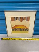 Full view of framed print with tape measure for scale