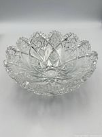 Oblique side view of the cut crystal bowl showing external cut pattern and scalloped rim